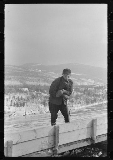 Untitled photo, possibly related to: Workmen dumping the ice and snow from streets of Berlin, New Hampshire, into river