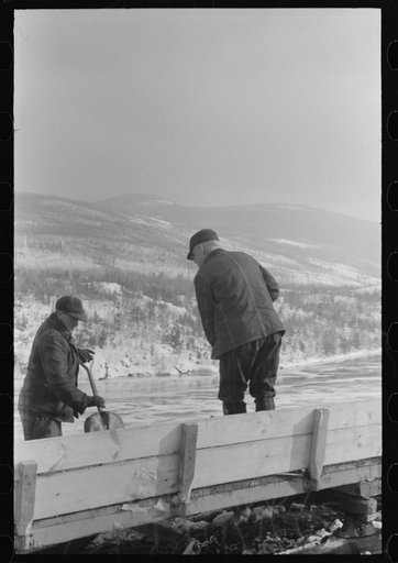 Untitled photo, possibly related to: Workmen dumping the ice and snow from streets of Berlin, New Hampshire, into river