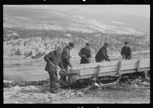 Untitled photo, possibly related to: Workmen dumping the ice and snow from streets of Berlin, New Hampshire into river