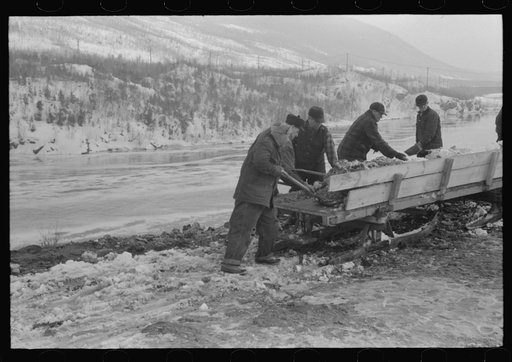 Untitled photo, possibly related to: Workmen dumping the ice and snow from streets of Berlin, New Hampshire into river