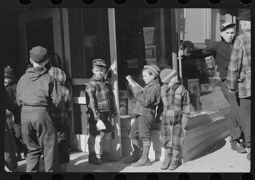Untitled photo, possibly related to: Children and farmers waiting to go into movie on Saturday afternoon, Littleton, New Hampshire