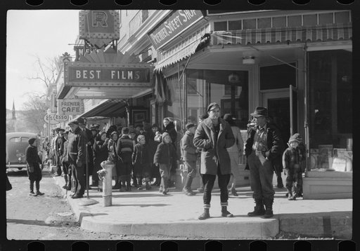 Children and farmers waiting to go into movie on Saturday afternoon. Littleton, New Hampshire