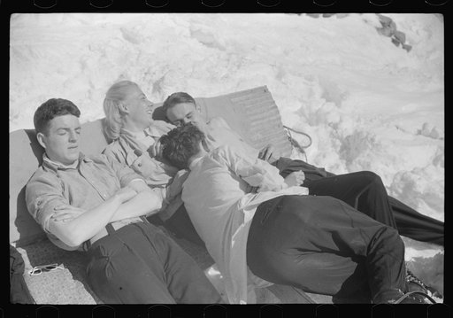 Skiers relaxing in the sun during noon hour outside of forest ranger's hut near the top of Mount Mansfield, Smuggler's Notch, near Stowe, Vermont