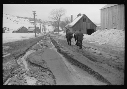 Woodstock (vicinity), Vermont. Clinton Gilbert driving a team down the road to his farm during a spring thaw