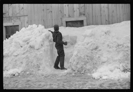 Untitled photo, possibly related to: Young son of Clinton Gilbert shoveling snow away from window of barn to let in some light. Clinton Gilbert farm near Woodstock, Vermont