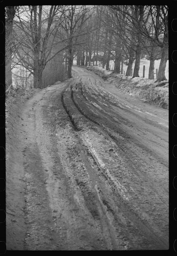 Muddy road after thaw, near Stowe, Vermont