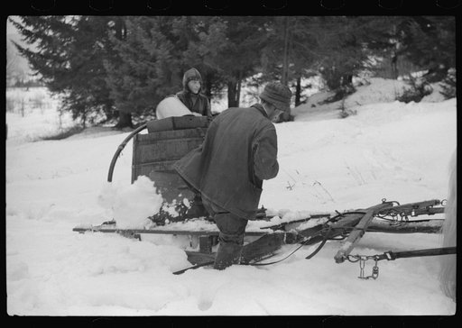 Untitled photo, possibly related to: Walter Gaylord and son on sled with vat full of sap from sugar maple trees which is boiled down into syrup. Mad River Valley, Waitesfield, Vermont. He averages about 150 gallons of syrup annually, this year tapped only 600 out of his 1000 trees, because of unusua
