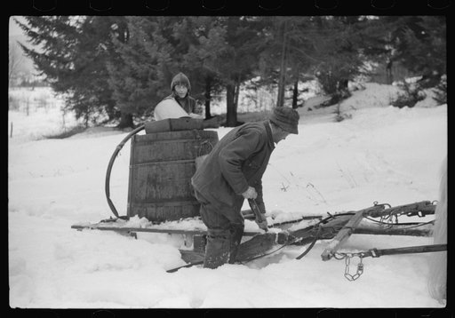 Untitled photo, possibly related to: Walter Gaylord and son on sled with vat full of sap from sugar maple trees which is boiled down into syrup. Mad River Valley, Waitesfield, Vermont. He averages about 150 gallons of syrup annually, this year tapped only 600 out of his 1000 trees, because of unusua
