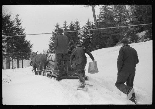 Untitled photo, possibly related to: Walter Gaylord and son on sled with vat full of sap from sugar maple trees which is boiled down into syrup. Mad River Valley, Waitesfield, Vermont. He averages about 150 gallons of syrup annually, this year tapped only 600 out of his 1000 trees, because of unusua