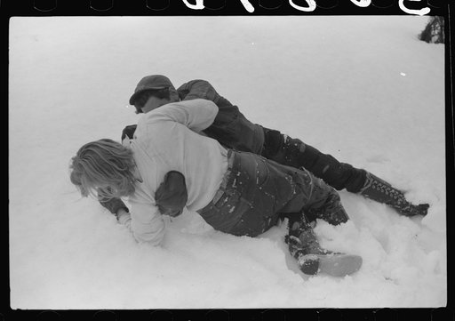 Hired man and young neighbor of Frank H. Shurtleff "rough housing" in the snow while gathering sap from sugar trees for making maple syrup. Sugaring is a social event and is enjoyed by all the young people and children in the neighborhood. The Shurtleff farm has about 400 acres and was originally pu