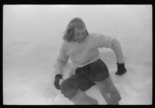 Untitled photo, possibly related to: Young neighbor of Frank H. Shurtleff resting in the snow while gathering sap from sugar trees for making maple syrup. Sugaring is a social event and is enjoyed by all young people and children in the neighborhood. The Shurtleff farm has about 400 acres and was or