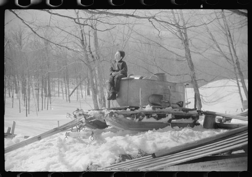 Mr. Shurtleff's child sitting on top of vat and sled in which sap for maple syrup is gathered. Bridgewater, near Woodstock, Vermont