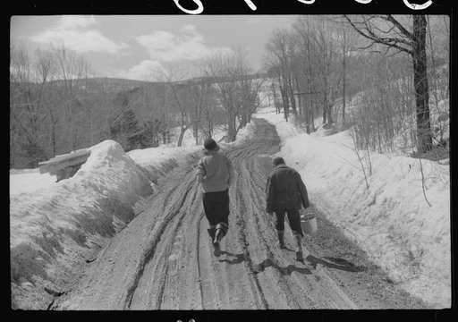 Two farmer's children going home after visiting a neighbor during spring thaw near Woodstock, Vermont
