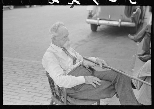 "Kentucky colonel" sitting in street in front of courthouse. Versailles, Kentucky