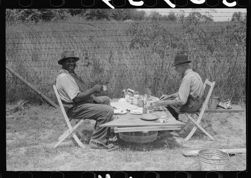 Stable hand and trainer eating picnic lunch before the Shelby County Horse Show and Fair, Shelbyville, Kentucky