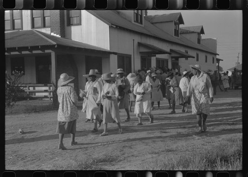 Day laborers who have just been paid off for hoeing cotton on the Hopson Plantation near Clarksdale, Mississippi Delta, Mississippi