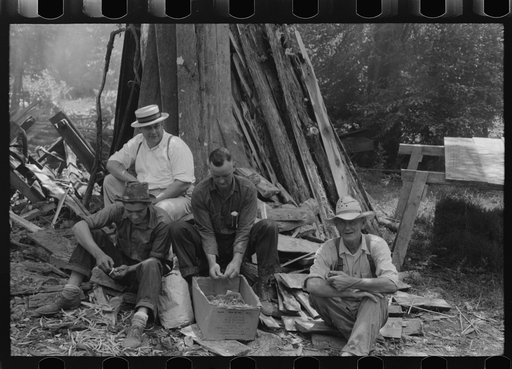 Parishoners peeling potatoes for a benefit picnic supper on the grounds of St. Thomas' Church. Near Bardstown, Kentucky