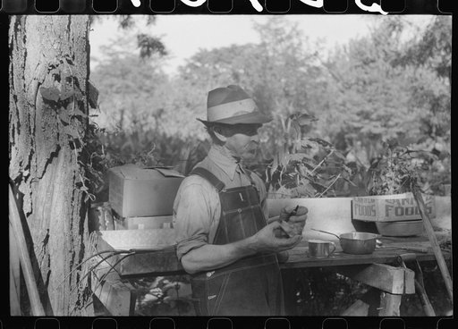 Picnicker peeling apple at St. Thomas church supper, near Bardstown, Kentucky