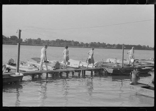 Untitled photo, possibly related to: People from Louisville, Kentucky, taking a picnic supper on their boat on the Ohio River