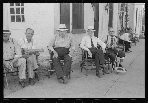 Townspeople visiting while sitting in front of Old Talbott Tavern on Saturday afternoon. Bardstown, Kentucky