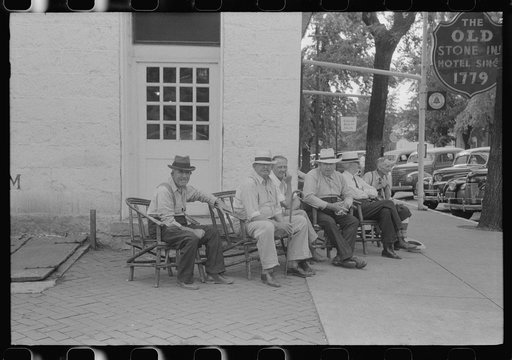 Townspeople visiting while sitting in front of Old Talbott Tavern on Saturday afternoon. Bardstown, Kentucky