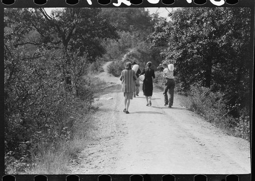 Untitled photo, possibly related to: Mountaineers crossing the Kentucky River over swinging bridge, carrying their supplies home from Jackson, Breathitt County, Kentucky