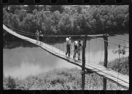 Carrying home groceries and supplies across the swinging bridge, Breathitt County, Jackson, Kentucky