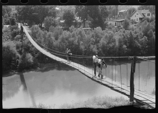 Untitled photo, possibly related to: Mountaineers crossing the Kentucky River over swinging bridge, carrying their supplies home from Jackson, Breathitt County, Kentucky