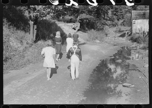 Untitled photo, possibly related to: Children going home from school up Frozen Creek carrying their lunch pails. School is held in the summer and stops in January because the creek beds, roads and inadequate clothing make it impossible for them to come in severe weather. Breathitt County, Kentucky