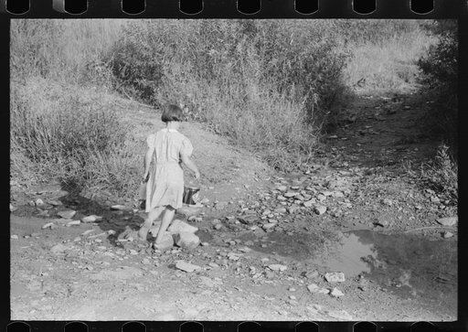 Untitled photo, possibly related to: Children going home from school up Frozen Creek carrying their lunch pails. School is held in the summer and stops in January because the creek beds, roads and inadequate clothing make it impossible for them to come in severe weather. Breathitt County, Kentucky