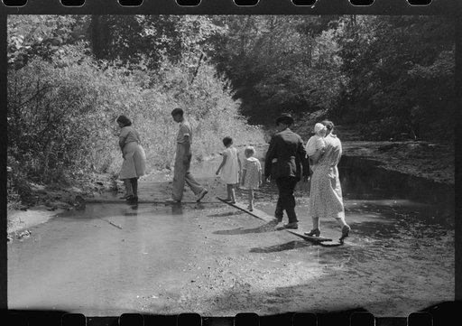 Mountain people leaving the Primitive Baptist Church in Morehead, Kentucky, and going down to the creek for a baptizing