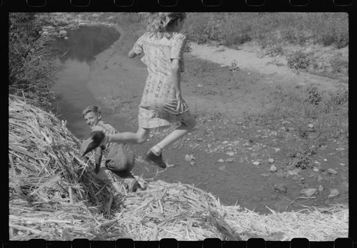 Untitled photo, possibly related to: Pouring off and straining finished sorghum syrup after it had been boiled down at a "syruping off" on the highway between Jackson and Campton, Kentucky