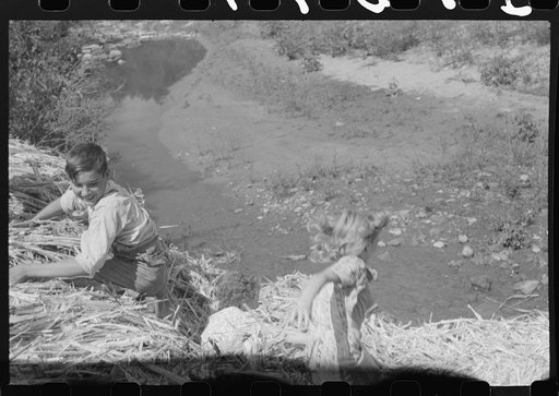 Untitled photo, possibly related to: Pouring off and straining finished sorghum syrup after it had been boiled down at a "syruping off" on the highway between Jackson and Campton, Kentucky