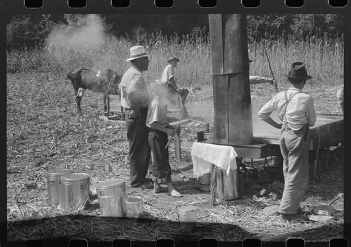 Untitled photo, possibly related to: Boiling down the sorghum cane sap into syrup. At a mountaineer's home on the highway between Jackson and Campton, Kentucky