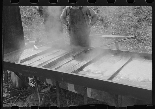 Boiling down the sorghum cane sap into syrup. At a mountaineer's home on the highway between Jackson and Campton, Kentucky