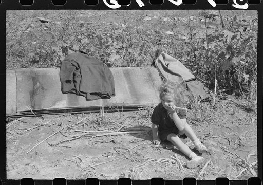 Untitled photo, possibly related to: In the early fall during "syruping off" time many of the children stay home from school to eat the freshly boiled down sorghum cane syrup. The cook usually goes to the various farms in the neighborhood and for his work takes a share of the syrup. On the highway b