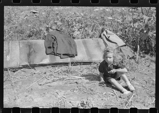 Untitled photo, possibly related to: In the early fall during "syruping off" time many of the children stay home from school to eat the freshly boiled down sorghum cane syrup. The cook usually goes to the various farms in the neighborhood and for his work takes a share of the syrup. On the highway b