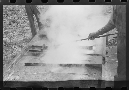 Boiling down the sorghum cane sap into syrup. At a mountaineer's home on the road between Jackson and Campton, Kentucky