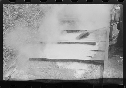 Untitled photo, possibly related to: Boiling down the sorghum cane sap into syrup. At a mountaineer's home on the road between Jackson and Campton, Kentucky