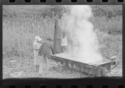 Untitled photo, possibly related to: In the early fall during "syrupping off" time many of the children stay home from school to eat the freshly boiled down sorghum cane syrup. The cook usually goes to the various farms in the neighborhood and for his work takes a share of the syrup. On the highway 