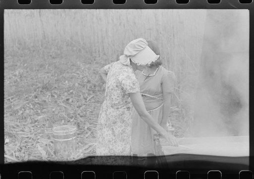 Untitled photo, possibly related to: In the early fall during "syrupping off" time many of the children stay home from school to eat the freshly boiled down sorghum cane syrup. The cook usually goes to the various farms in the neighborhood and for his work takes a share of the syrup. On the highway 