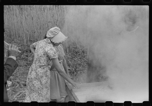 Untitled photo, possibly related to: In the early fall during "syrupping off" time many of the children stay home from school to eat the freshly boiled down sorghum cane syrup. The cook usually goes to the various farms in the neighborhood and for his work takes a share of the syrup. On the highway 