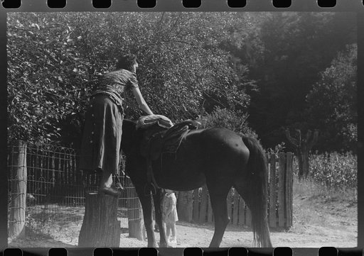 Woman using mounting block up Burton's Fork, Kentucky River, near Jackson, Kentucky
