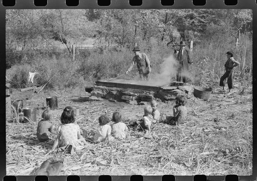 Untitled photo, possibly related to: Homebuilt boiler pit made of mud and rocks where the sap from the sorghum cane is boiled down to the syrup.The man who does the cooking goes from one farmhouse to another and takes a share of the syrup for his work at the different mountaineers' homes in Breathit