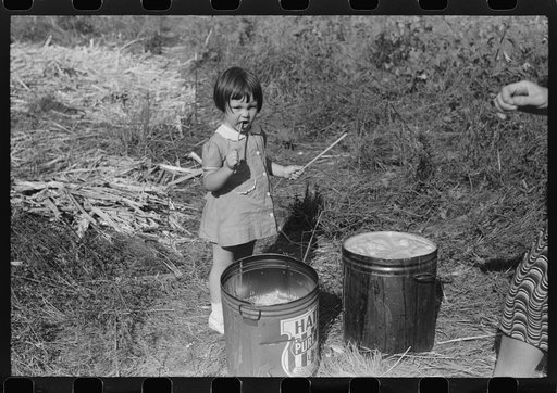 Mountaineer's daughter enjoying the sorghum syrup at a neighbor's home during a "syrupping off," Breathitt County, Kentucky