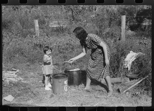Mountaineer's daughter and her mother enjoying the sorghum syrup at a neighbor's home during a "syrupping off," Breathitt County, Kentucky