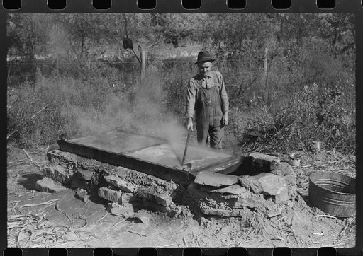 Homebuilt boiler pit made of mud and rocks where the sap from the sorghum cane is boiled down to the syrup.The man who does the cooking goes from one farmhouse to another and takes a share of the syrup for his work at the different mountaineers' homes in Breathitt County, Kentucky