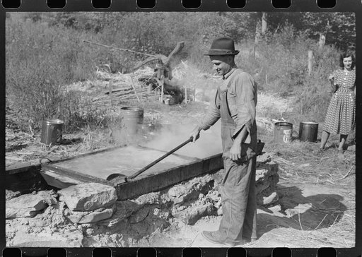 Untitled photo, possibly related to: Homebuilt boiler pit made of mud and rocks where the sap from the sorghum cane is boiled down to the syrup.The man who does the cooking goes from one farmhouse to another and takes a share of the syrup for his work at the different mountaineers' homes in Breathit