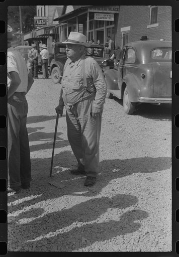 Farmer listening to itinerant salesman on court day, Campton, Kentucky