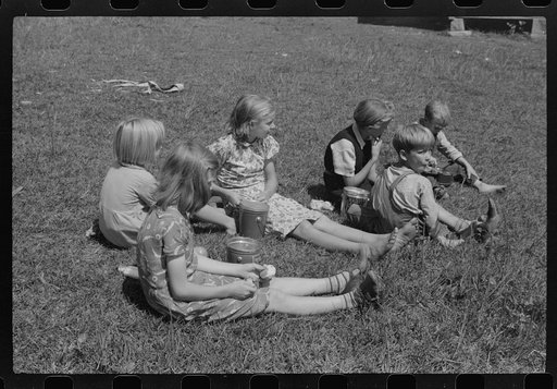 Untitled photo, possibly related to: Child eating lunch during the noon hour at school in Breathitt County, Kentucky. In his lunch pail were cold potatoes, corn bread and mush